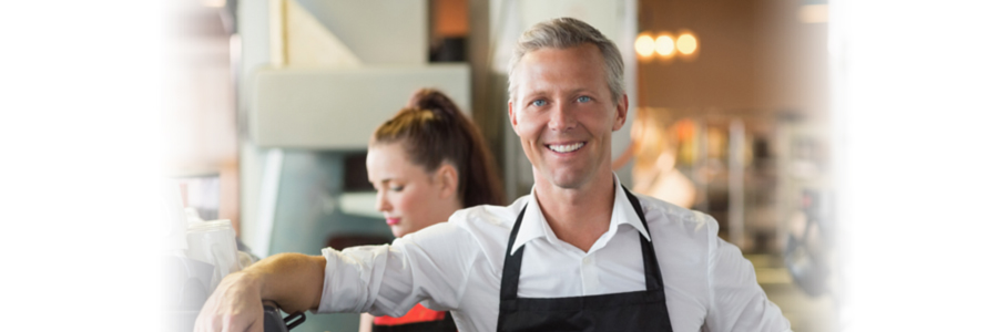 A coffee shop owner smiling